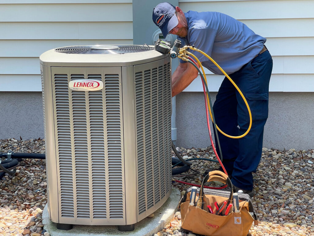 AC tech repairing an air conditioning unit