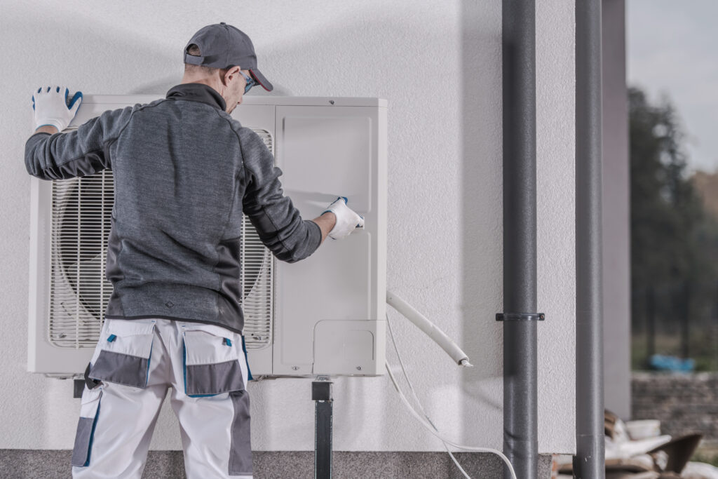 Heat pump being repaired by a technician.